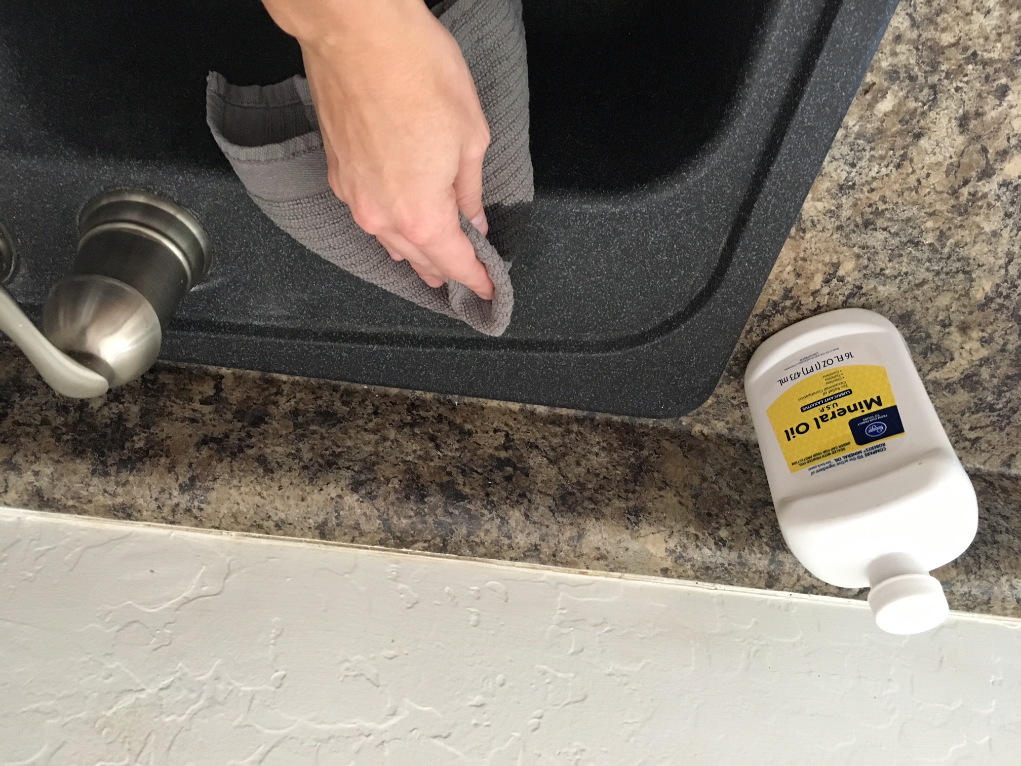 applying mineral oil to black kitchen sink