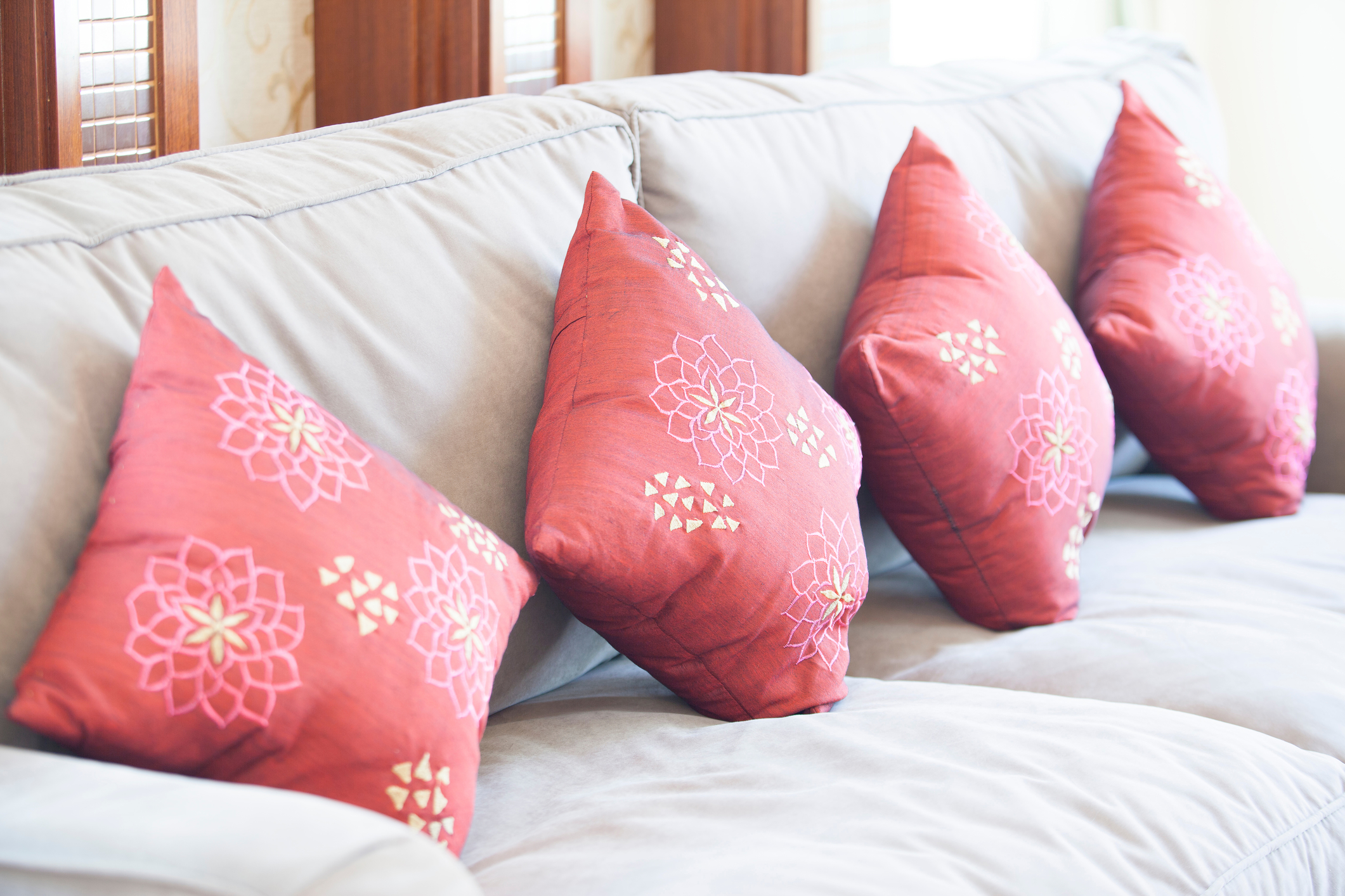 Fabric sofa with red pillows