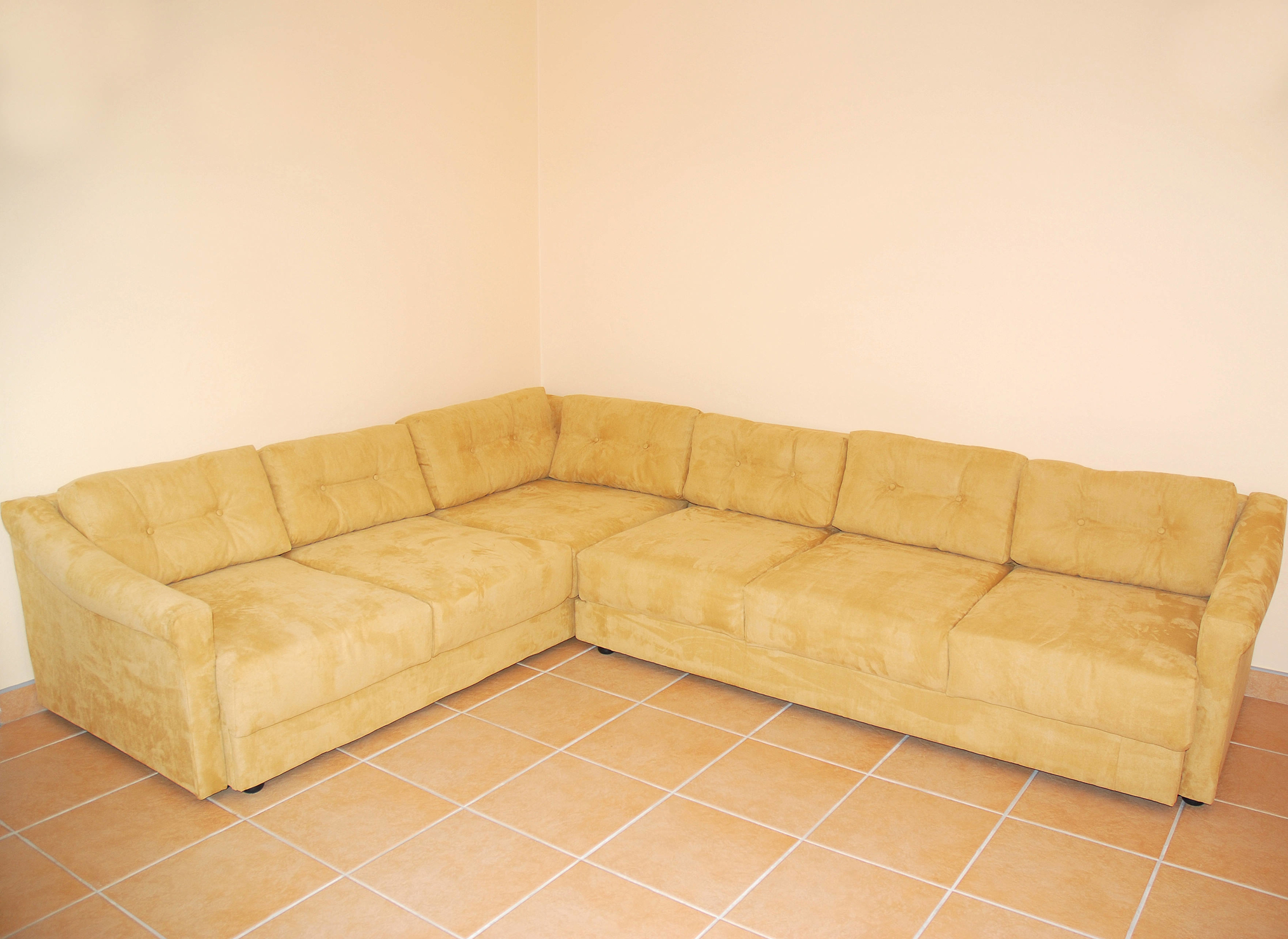A plain beige corner sofa