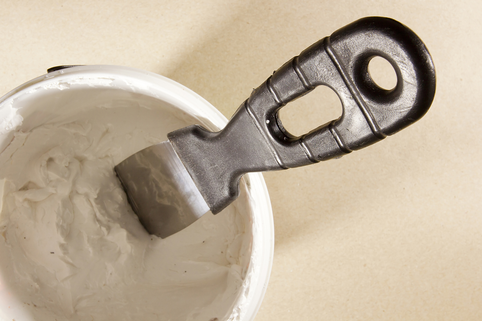 Putty Knife with Spackling Paste to Repair Wall Damage