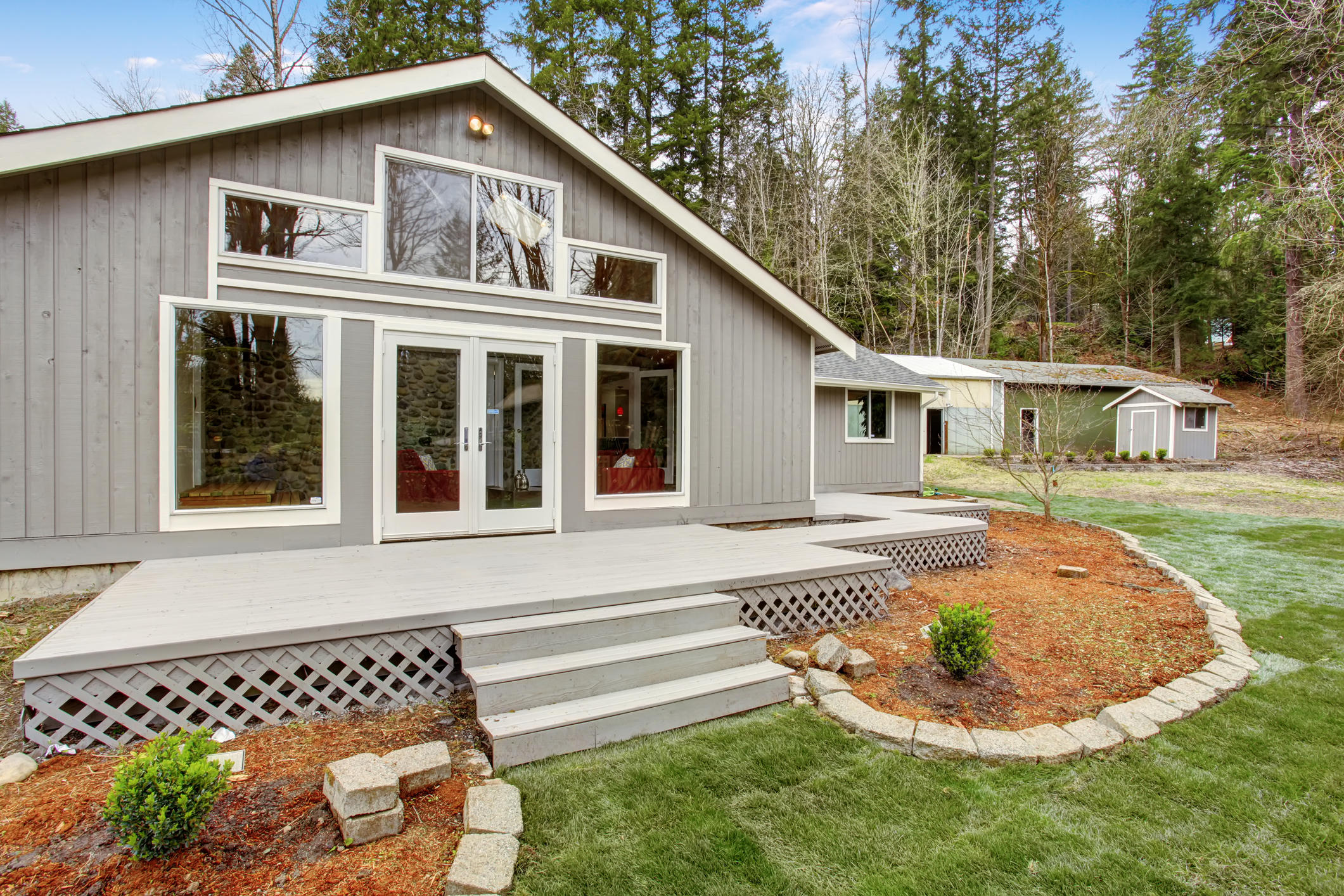 Lovely back yard with porch, and grass.