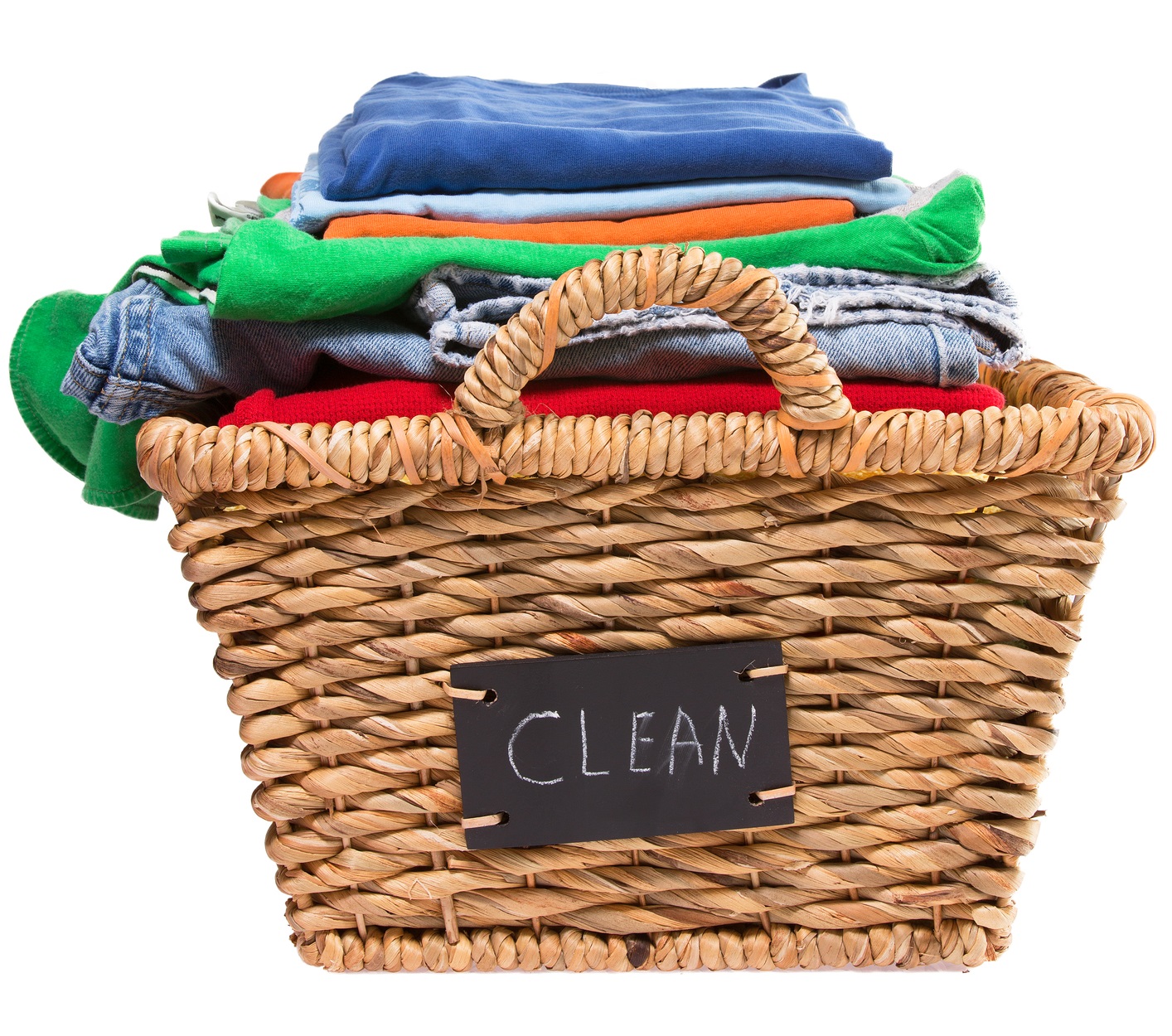 Wicker laundry basket filled with stack of folded colorful clean clothes ready for ironing with a handwritten label on the side of the basket saying - Clean
