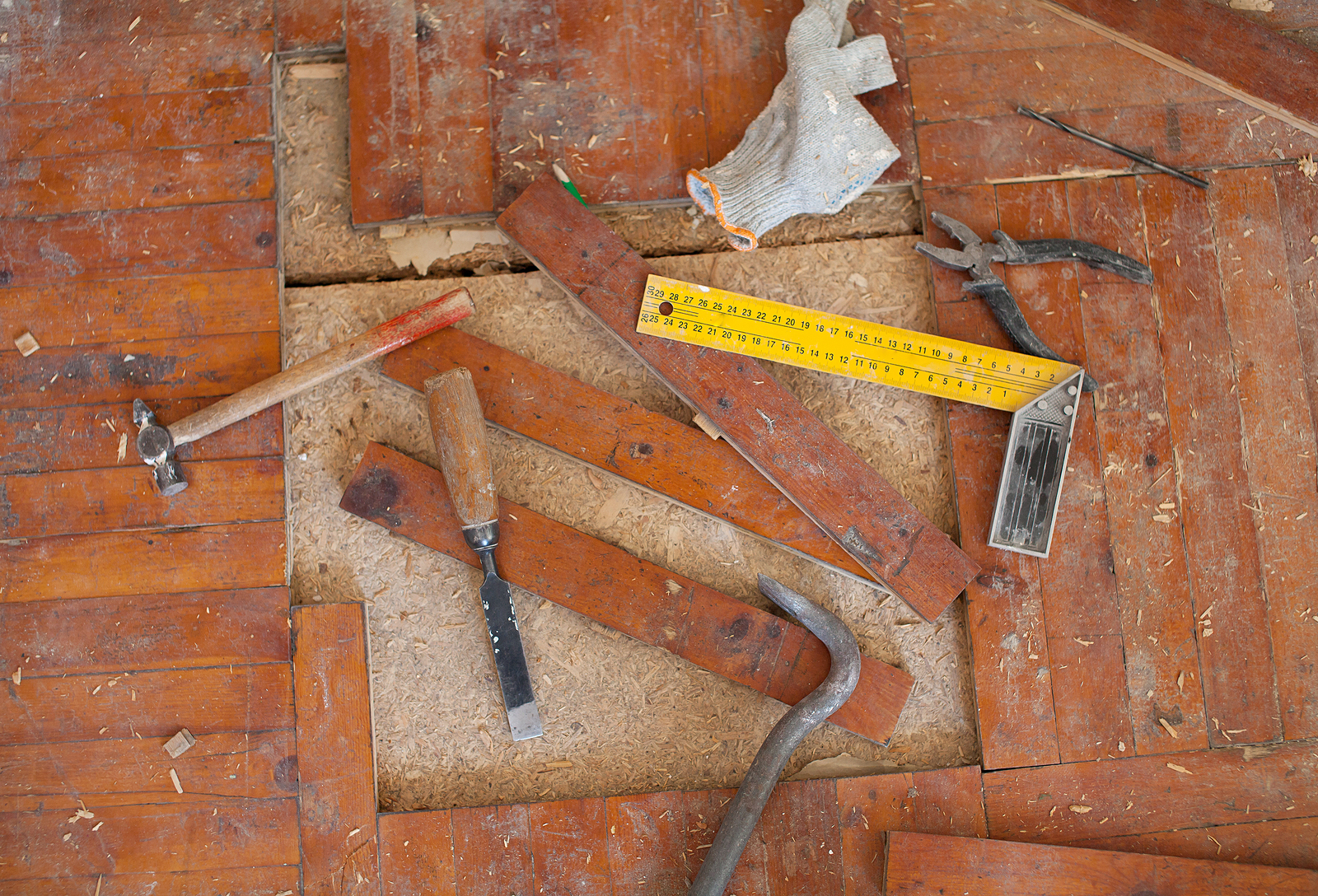 Old rotten parquet floor remove with chisel, hammer tools
