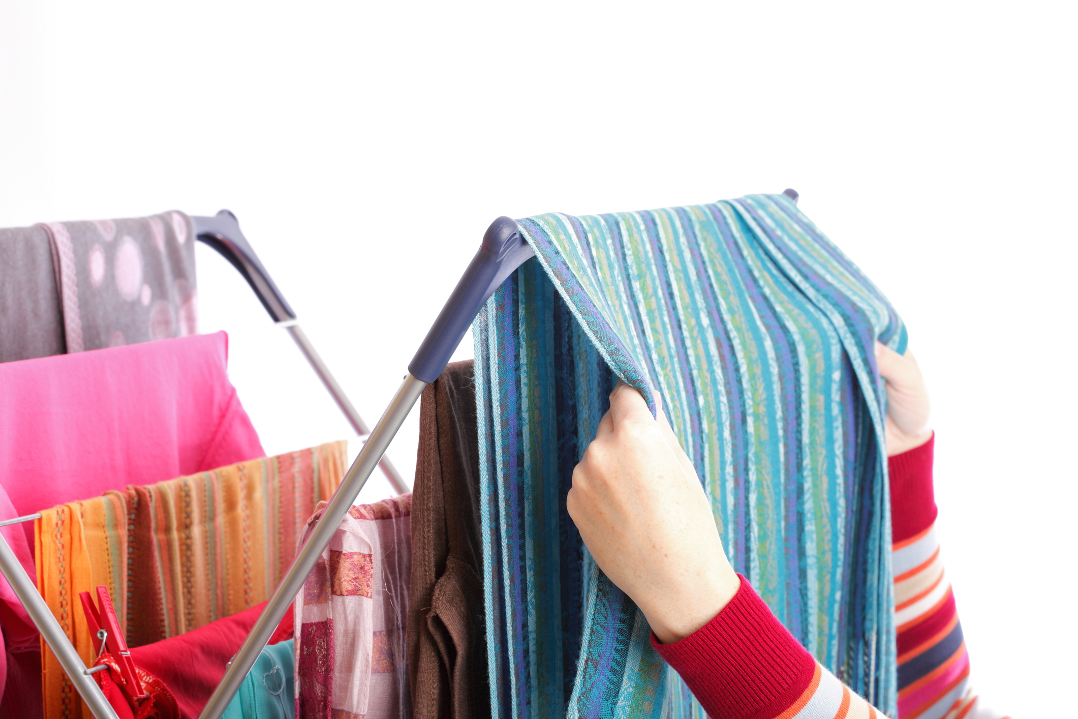 Colorful clothes hanged for drying after laundry clothes airer